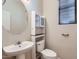 Cozy half bathroom with pedestal sink and built-in shelving at 1710 S Parkcrest St, Gilbert, AZ 85295
