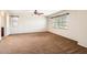 Spacious carpeted bedroom with abundant natural light from two windows at 1710 S Parkcrest St, Gilbert, AZ 85295