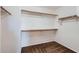 Walk-in closet with built-in shelves and rods for organized storage at 1710 S Parkcrest St, Gilbert, AZ 85295