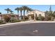 Charming community clubhouse with desert landscaping, mature palm trees, and an American flag at 1710 S Parkcrest St, Gilbert, AZ 85295