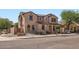 Two-story home featuring neutral colored stucco exterior, arched windows and terracotta roof tiles at 1710 S Parkcrest St, Gilbert, AZ 85295