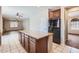 An open-concept kitchen featuring a center island, tile flooring, and seamless access to other living areas at 1710 S Parkcrest St, Gilbert, AZ 85295