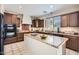 Spacious kitchen featuring an island, granite countertops, stainless steel appliances, and dark wood cabinets at 1710 S Parkcrest St, Gilbert, AZ 85295