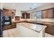 Spacious kitchen featuring an island, granite countertops, stainless steel appliances, and dark wood cabinets at 1710 S Parkcrest St, Gilbert, AZ 85295