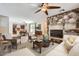 Open-concept living room features wood floors, stone fireplace, and seamless flow to the kitchen at 1710 S Parkcrest St, Gilbert, AZ 85295