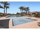 Community pool area featuring a large pool, spa, lounge chairs and mature palm trees at 1710 S Parkcrest St, Gilbert, AZ 85295