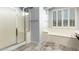 Bright bathroom featuring a glass enclosed shower and a soaking tub under a window with shutters at 17853 W Pershing St, Surprise, AZ 85388