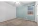 Bedroom with carpeted floors, ceiling fan, neutral walls, and a window at 17853 W Pershing St, Surprise, AZ 85388