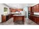 Spacious kitchen featuring stainless steel appliances, dark wood cabinets and a center island at 17853 W Pershing St, Surprise, AZ 85388