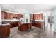 Spacious kitchen featuring stainless steel appliances, dark wood cabinets and a center island at 17853 W Pershing St, Surprise, AZ 85388