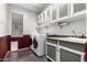 Bright laundry room features modern appliances, cabinets and a sink at 17853 W Pershing St, Surprise, AZ 85388