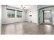 Bright living room with wood floors, ceiling fan, and doorway to another room at 17853 W Pershing St, Surprise, AZ 85388