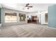 Open living room with carpet and recessed lights showcasing connecting kitchen and dining area at 17853 W Pershing St, Surprise, AZ 85388