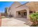 Covered outdoor patio with ceiling fan and views of the manicured backyard with mature shrubbery at 17853 W Pershing St, Surprise, AZ 85388