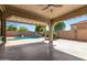 Covered outdoor patio with a view of the backyard swimming pool at 17853 W Pershing St, Surprise, AZ 85388