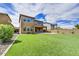 Expansive backyard with manicured lawn, patio, and views of the surrounding neighborhood at 1854 W Fetlock Trl, Phoenix, AZ 85085