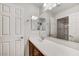 Bright bathroom featuring a white vanity, expansive mirror, and a separate enclosed shower at 1854 W Fetlock Trl, Phoenix, AZ 85085