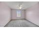 Cozy bedroom with carpet, ceiling fan, and a window providing natural light at 1854 W Fetlock Trl, Phoenix, AZ 85085