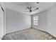 Well-lit bedroom with soft, neutral carpet, a ceiling fan, and plenty of natural light at 1854 W Fetlock Trl, Phoenix, AZ 85085