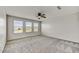 Bedroom with large windows, ceiling fan and neutral carpet at 1854 W Fetlock Trl, Phoenix, AZ 85085