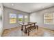 Bright dining room features a large wood table and bench seating under three windows at 1854 W Fetlock Trl, Phoenix, AZ 85085