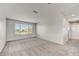 Bright, spacious living room offers a neutral color palette and plush carpet flooring at 1854 W Fetlock Trl, Phoenix, AZ 85085
