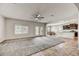 Open concept living room flowing into dining area and kitchen with ceiling fan at 1854 W Fetlock Trl, Phoenix, AZ 85085