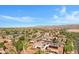This aerial view showcases the community with mature trees, a pond, and desert landscaping at 20082 N 272Nd Ln, Buckeye, AZ 85396