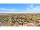 Wide aerial shot displaying a community with green spaces, complemented by desert landscape and mountain views at 20082 N 272Nd Ln, Buckeye, AZ 85396