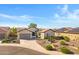 An aerial view showcasing a well-maintained home with solar panels and desert landscaping at 20082 N 272Nd Ln, Buckeye, AZ 85396