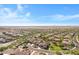 Gorgeous aerial captures a community with landscaping, revealing the layout of the tile-roofed homes at 20082 N 272Nd Ln, Buckeye, AZ 85396