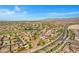 This aerial view showcases the community with mature trees, a pond, and desert landscaping at 20082 N 272Nd Ln, Buckeye, AZ 85396