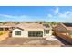 View of the backyard showcasing patio space, minimal landscaping, and a view of the surrounding community at 20082 N 272Nd Ln, Buckeye, AZ 85396