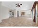 Spacious living room with tile flooring, ceiling fan, and sliding glass doors to bring in natural light at 20082 N 272Nd Ln, Buckeye, AZ 85396