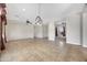 Bright, open-concept living room with stylish lighting, tile floors and open flow into other spaces at 20082 N 272Nd Ln, Buckeye, AZ 85396