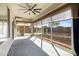 Enclosed sunroom with lots of windows, ceiling fan, and sliding door access to the outdoors at 20082 N 272Nd Ln, Buckeye, AZ 85396