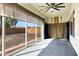 Enclosed sunroom with lots of windows, ceiling fan, and sliding door access to the outdoors at 20082 N 272Nd Ln, Buckeye, AZ 85396