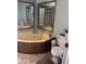 Bathroom with a corner soaking tub, toilet, and tile floor at 2011 N 26Th Cir, Mesa, AZ 85213