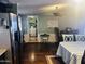View of open living area with appliances, desk, storage and laundry room at 2011 N 26Th Cir, Mesa, AZ 85213