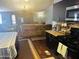 Open concept living and kitchen area with hardwood floors and modern appliances at 2011 N 26Th Cir, Mesa, AZ 85213