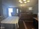 Open-concept living area with comfortable couches, dining table, and TV at 2011 N 26Th Cir, Mesa, AZ 85213