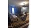 Comfortable living room with large window, ceiling fan, and matching seating arranged on an area rug at 2011 N 26Th Cir, Mesa, AZ 85213