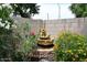 Soothing backyard fountain surrounded by vibrant plants and flowers creates a peaceful retreat at 2727 S 160 Ln, Goodyear, AZ 85338