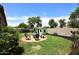 Landscaped backyard includes a fire pit area with chairs, and a cute playhouse for ' outdoor adventures at 2727 S 160 Ln, Goodyear, AZ 85338