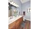 Bathroom featuring double sinks, wood cabinets, and a window at 2727 S 160 Ln, Goodyear, AZ 85338