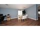 Dining room with stylish table, wood-look floors, and ample natural light at 2727 S 160 Ln, Goodyear, AZ 85338