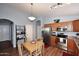 Cozy kitchen with stainless steel appliances, wooden cabinets, and eat-in dining area at 2727 S 160 Ln, Goodyear, AZ 85338
