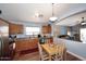 Kitchen with wooden cabinets, stainless steel appliances, and adjacent living area at 2727 S 160 Ln, Goodyear, AZ 85338