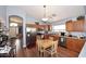 Well-equipped kitchen with stainless steel appliances, wooden cabinets, and adjacent dining area at 2727 S 160 Ln, Goodyear, AZ 85338
