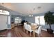 Open-concept living room featuring wood-look floors, dining area, and natural light at 2727 S 160 Ln, Goodyear, AZ 85338